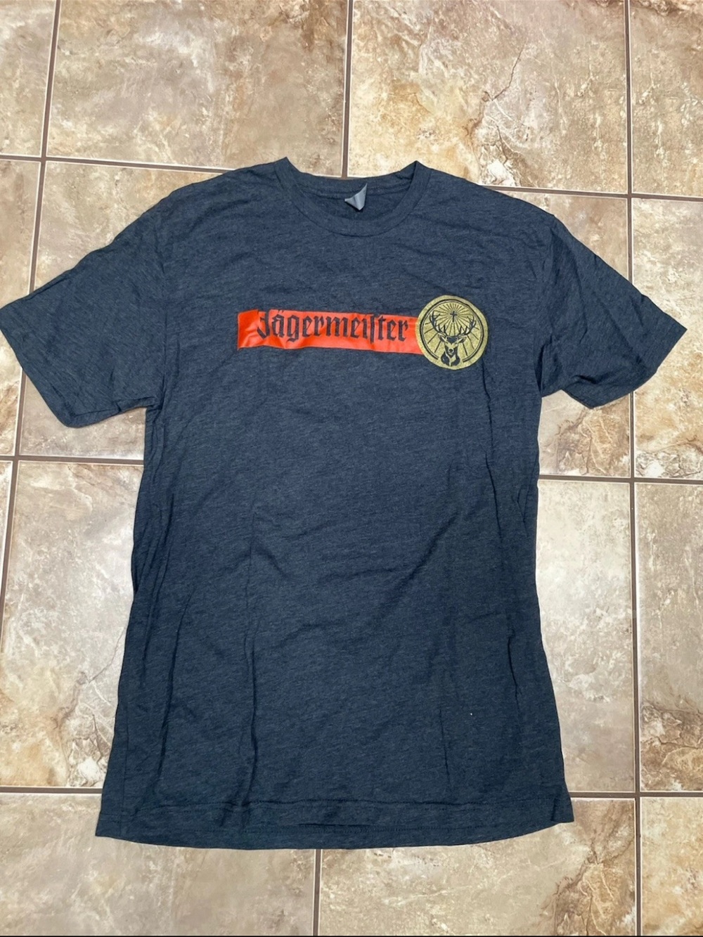 Jagermeister Black Short Sleeve Tee with Orange Logo and Gold Emblem